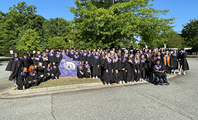  Seniors in Graduation Caps and gowns pose at Northern Elementary School